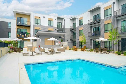 a swimming pool in front of some apartment buildings