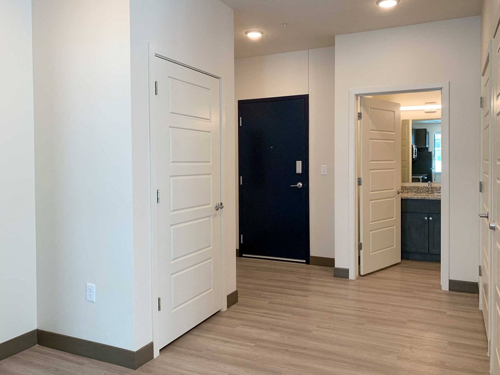 an entry way with a large coat closet and hall bathroom