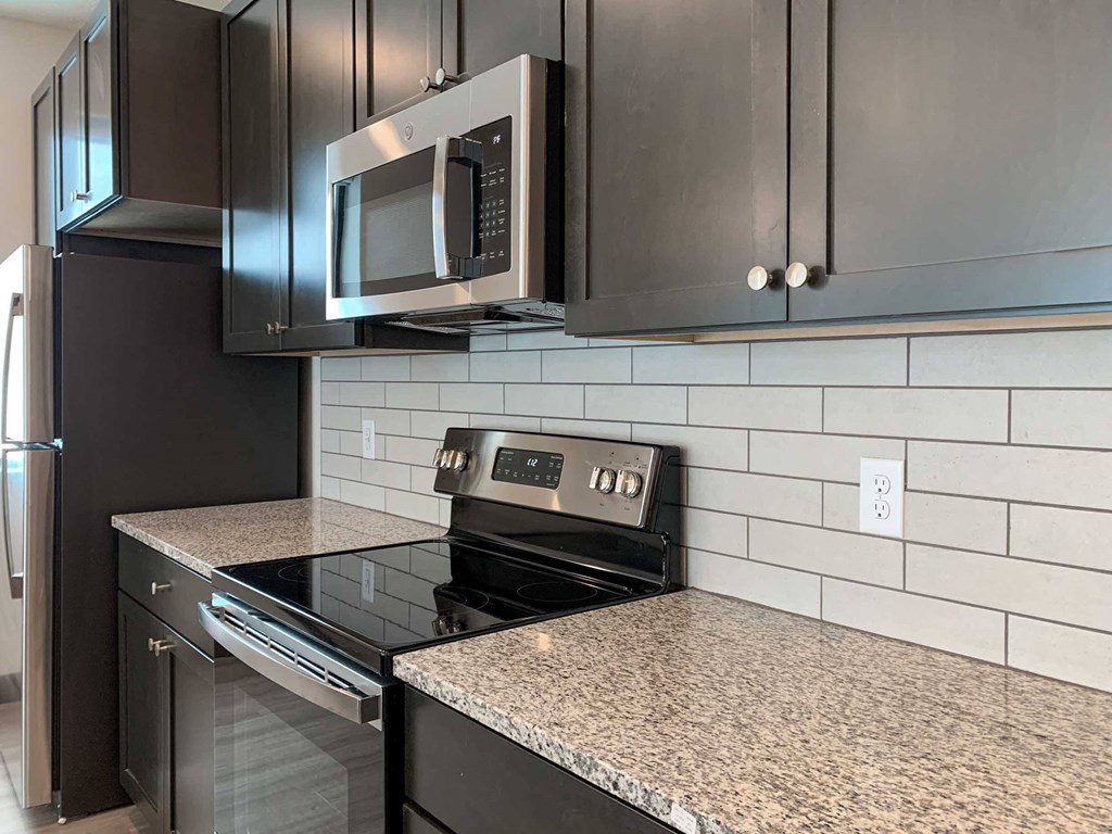 a kitchen with a stainless steel stove and a microwave