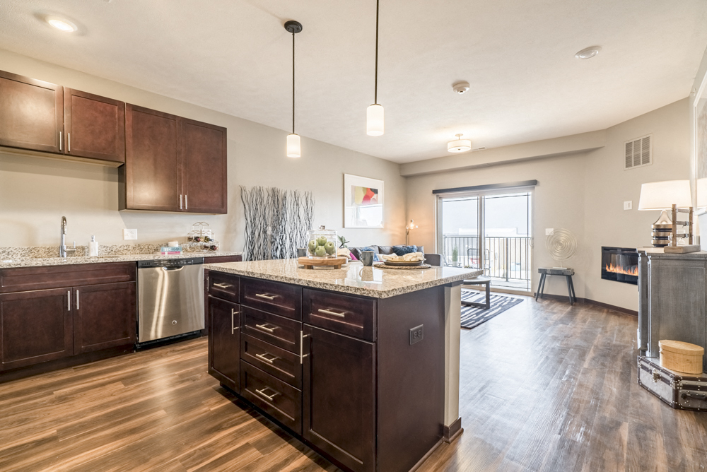 View from kitchen island with hardwood-style floors in one bedroom apartment for rent at 360 at Jordan West best new apartments West Des Moines IA 50266
