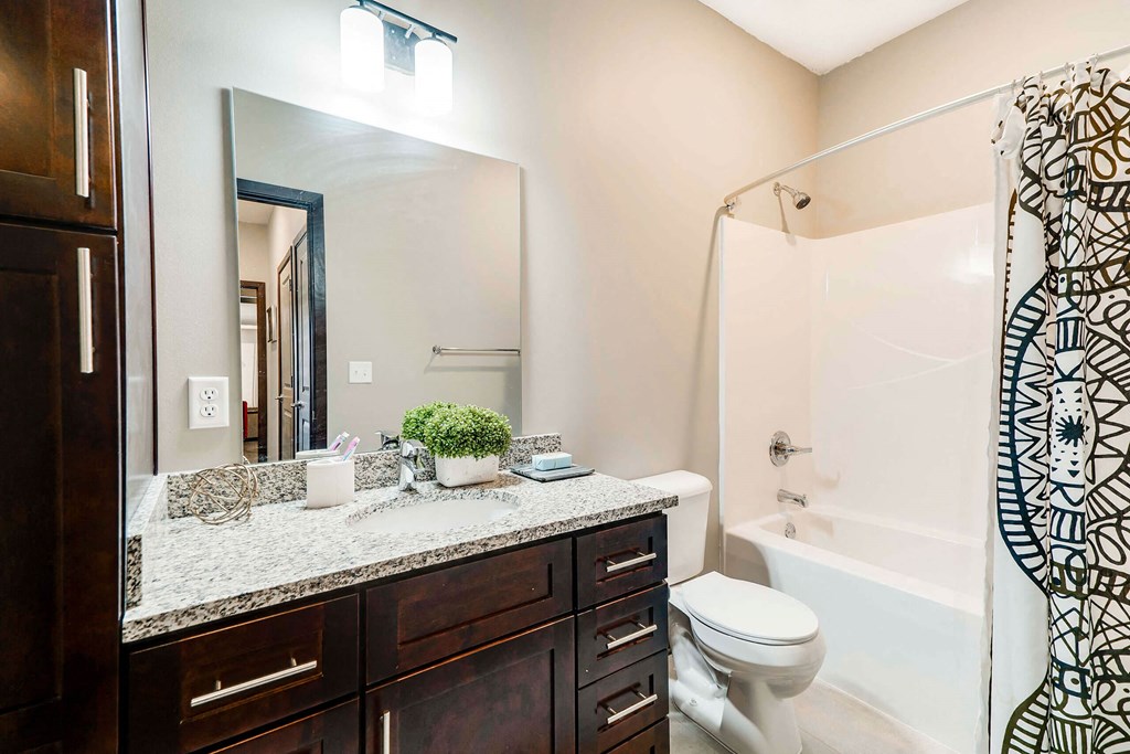 Spacious bathroom with tub shower and granite countertops in 2 bedroom apartment for rent at 360 at Jordan West best new apartments West Des Moines IA 50266