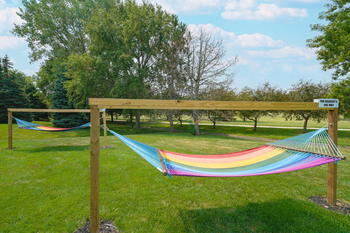 two rainbow striped hammocks outside the clubhouse at Williamsburg Park apartments in Lincoln
