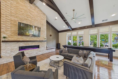 A living room with a fireplace and a painting on the wall.
