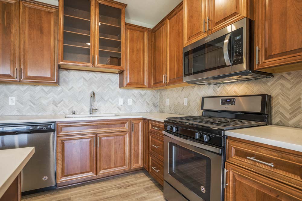 Premium design scheme with custom cabinetry and herringbone backsplash at Ascend at Woodbury MN 55129 new luxury apartments