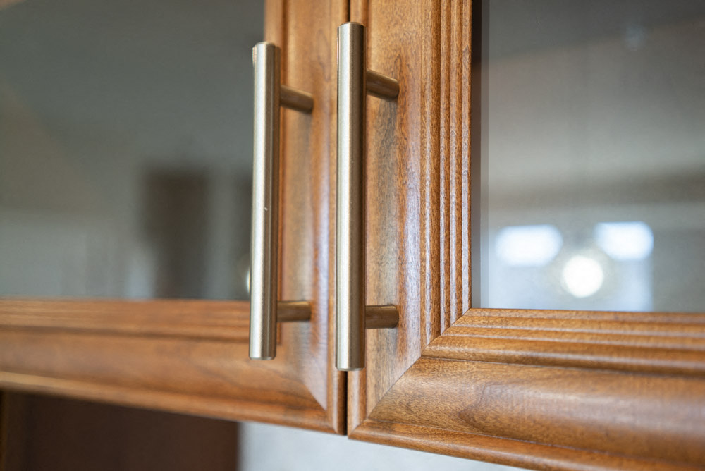 Glass-front accent cabinets in kitchen of at Ascend at Woodbury new luxury apartments in Woodbury MN 55129
