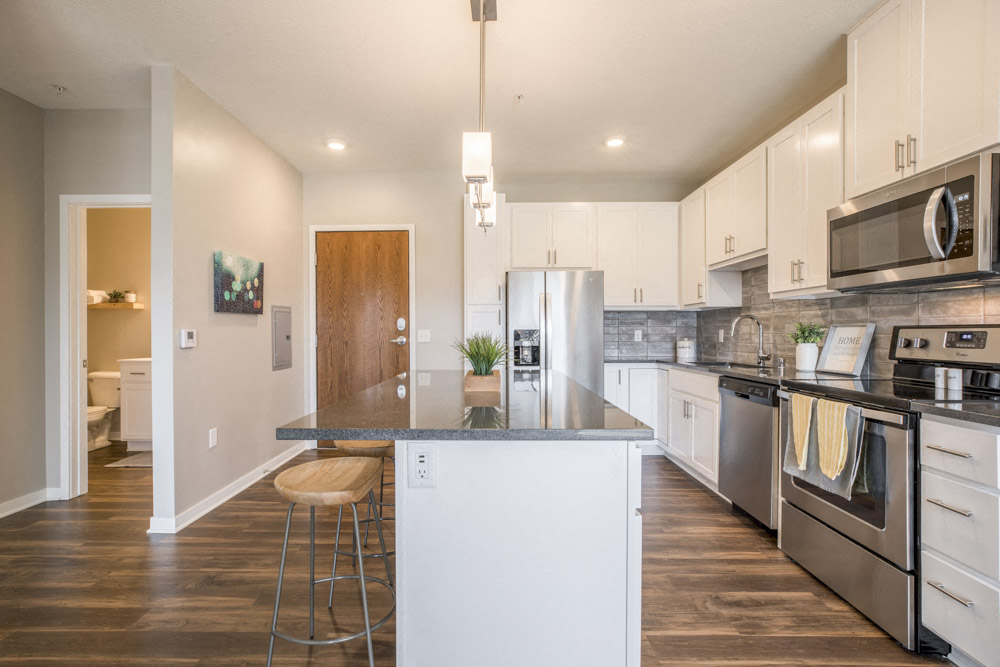 Alpine design scheme kitchen with white cabinets at Ascend at Woodbury new luxury apartments in Woodbury MN 55129