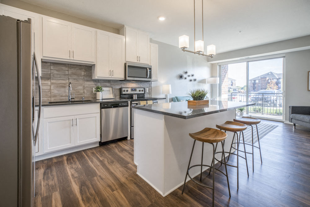 Kitchen with pendant lighting and island at Ascend at Woodbury new luxury apartments in Woodbury MN 55129