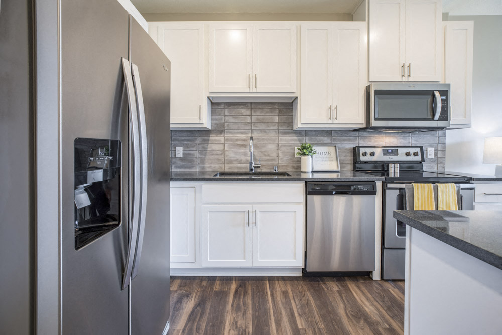 Stainless-steel appliances with side-by-side fridge at Ascend at Woodbury MN 55129 new luxury apartments