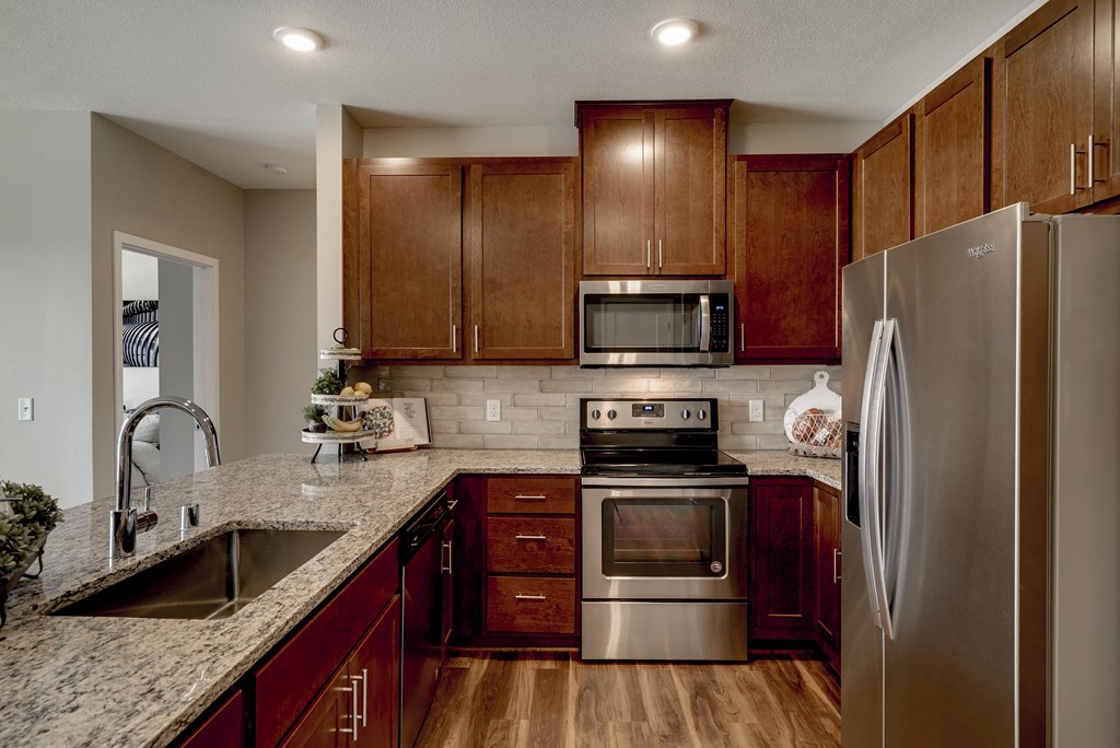 Luxury apartment with dark cabinetry and granite countertops at Ascend at Woodbury MN 55129 new luxury apartments