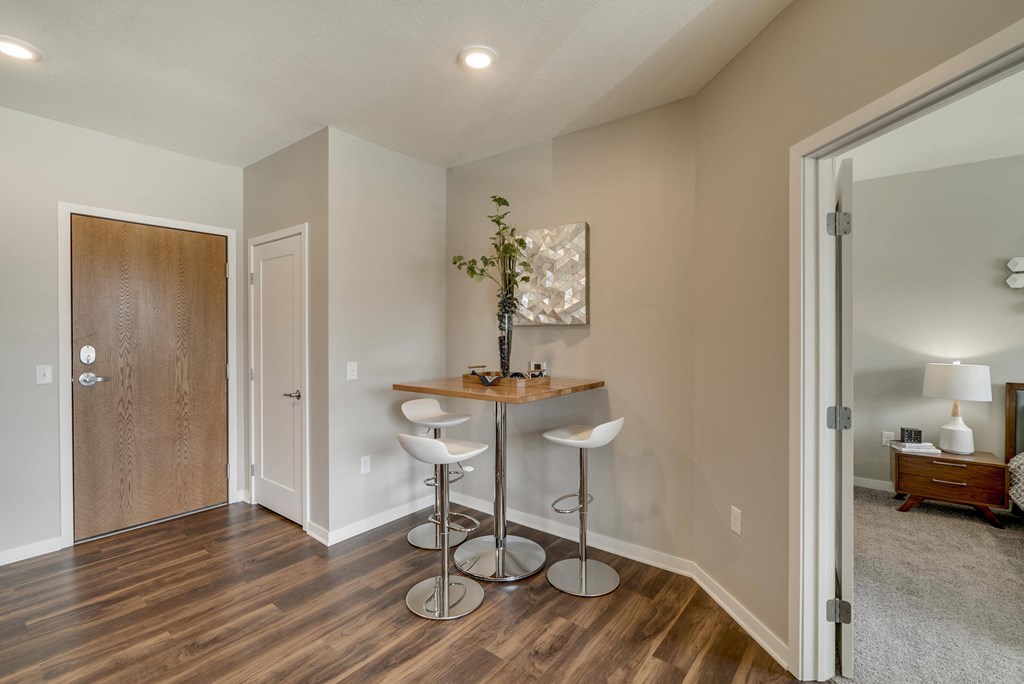 Living room in 2-bedroom apartment with hardwood-style floors and high ceilings at Ascend at Woodbury.