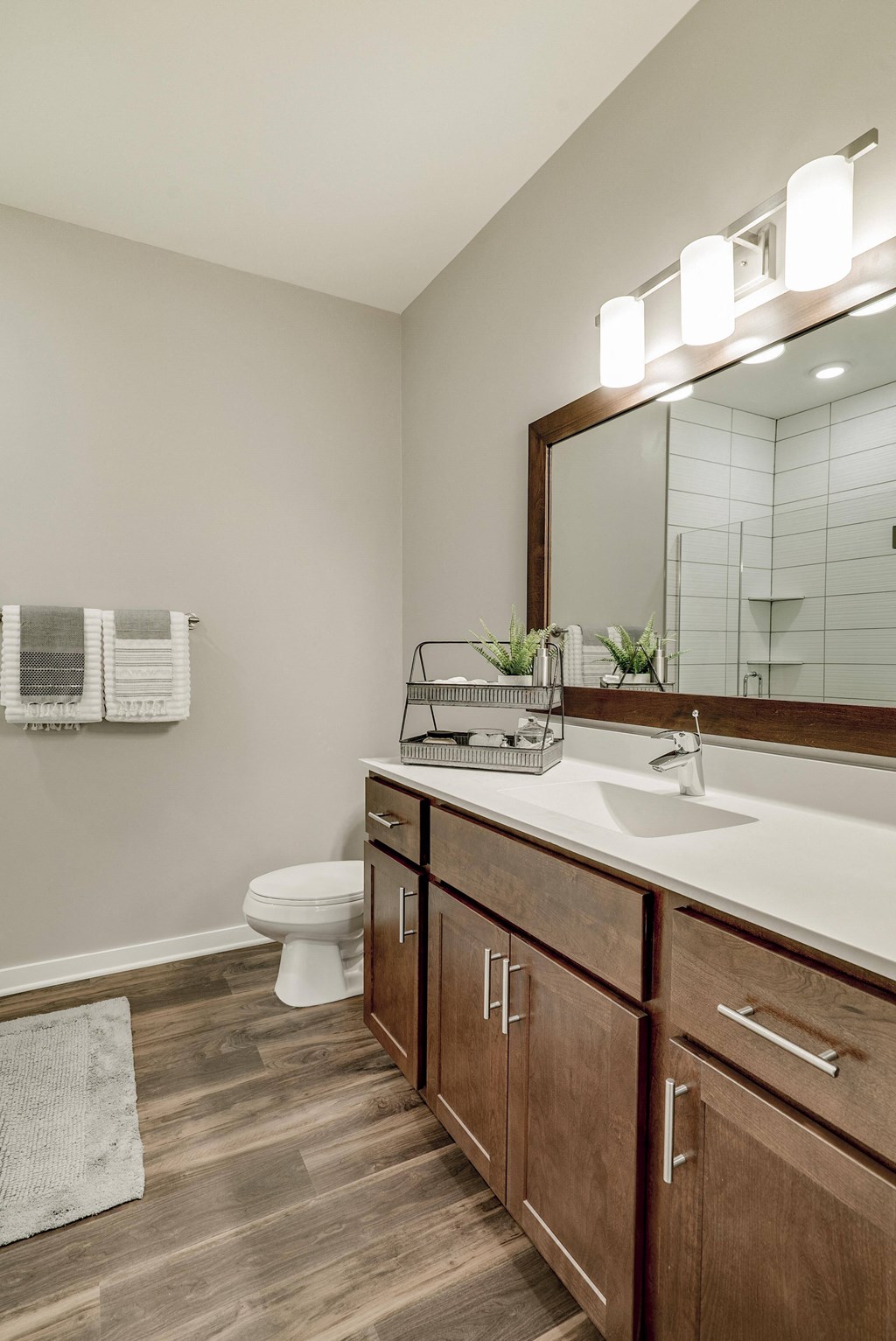 Bathroom with cherry cabinet vanity and great lighting at Ascend at Woodbury