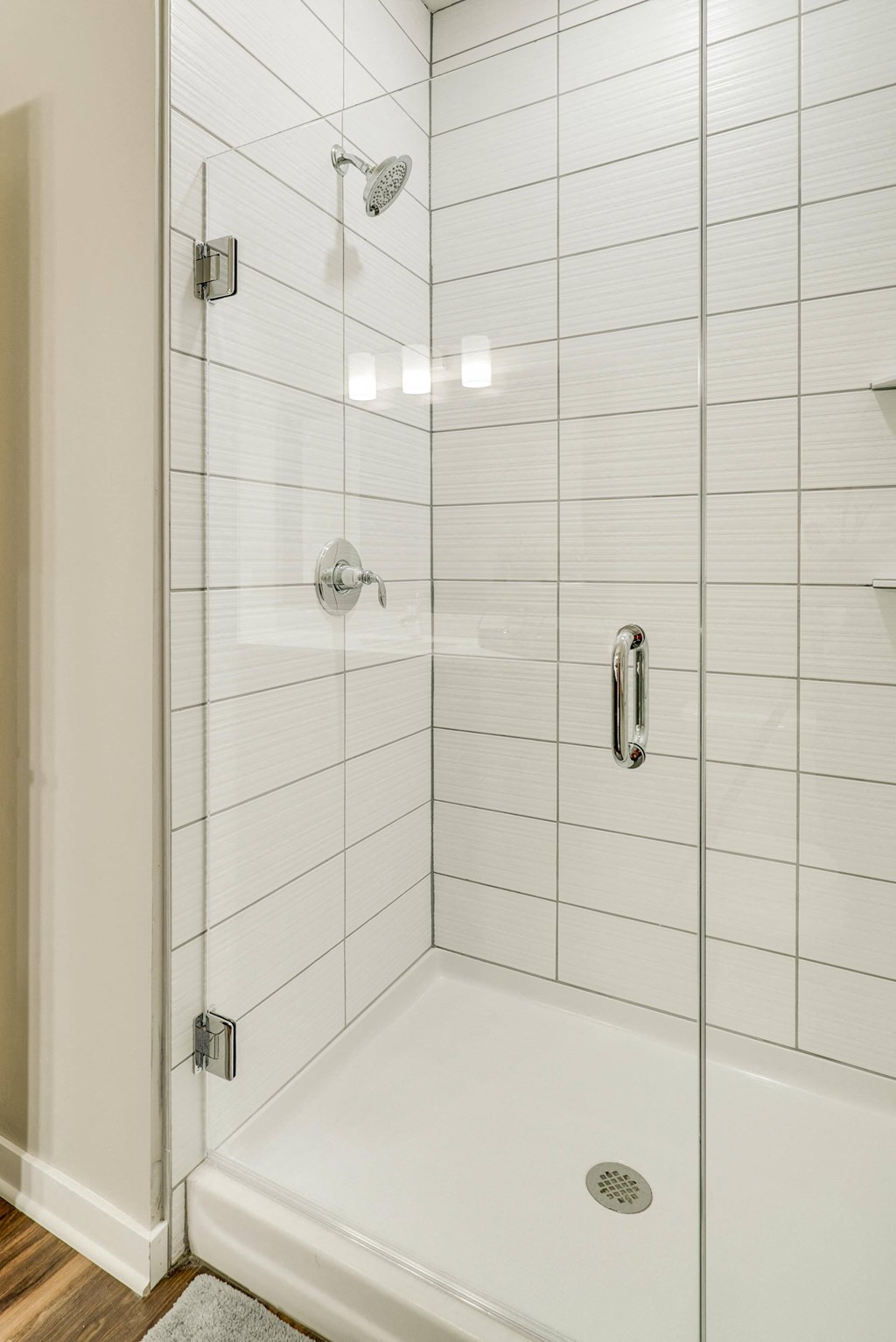 Shower with subway tile and glass doors at Ascend at Woodbury in MN