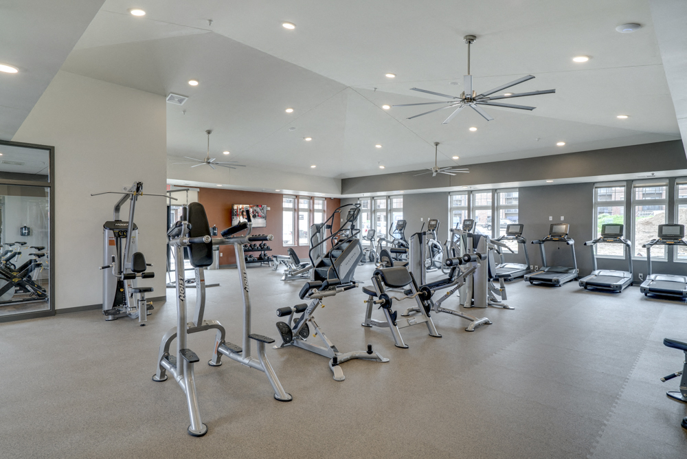 Large fitness center with free weights, weightlifting machines and cardio equipment at Ascend at Woodbury MN 55129 new luxury apartments