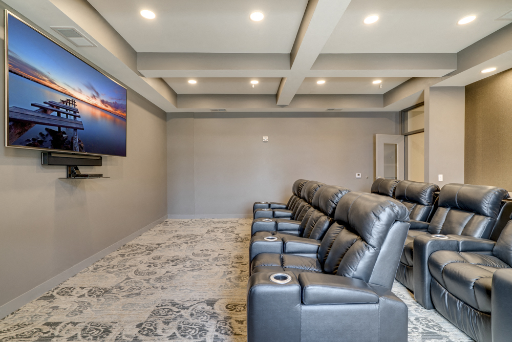 Theater room with leather seating and large TV at Ascend at Woodbury MN