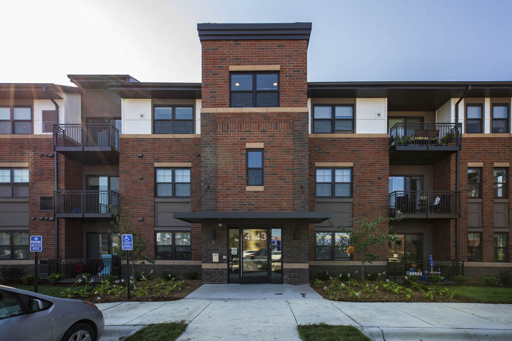 Exterior building view with controlled access entry at Ascend at Woodbury MN 55129 new luxury apartments