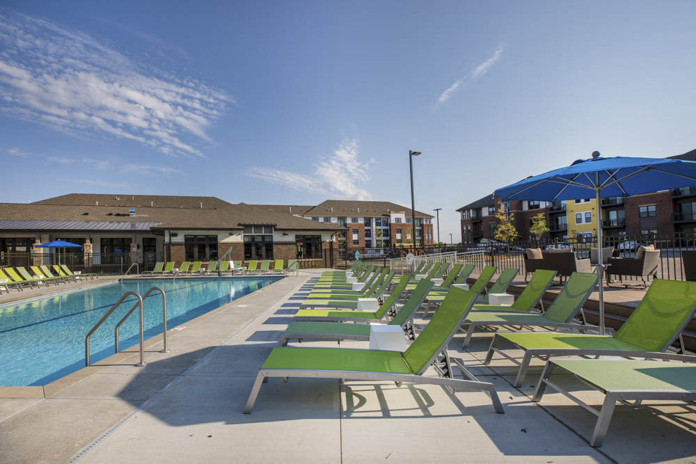 Lounge chairs next to resort-style pool at Ascend at Woodbury new luxury apartments in Woodbury MN 55129