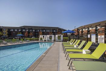Outdoor swimming pool with cabanas and lounge chairs at Ascend at Woodbury MN 55129 new luxury apartments