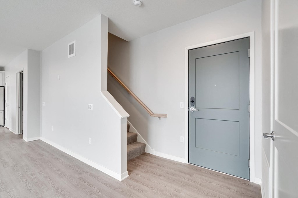 Entryway and carpeted staircase leading to second floor at Aspire at CityPlace in Woodbury, Minnesota