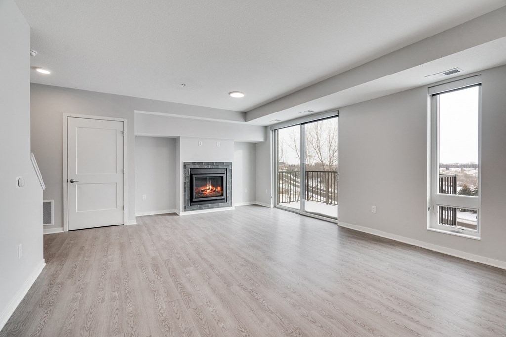 Spacious living and dining area with luxury electric fireplace and a lot of natural light at Aspire at CityPlace in Woodbury, Minnesota