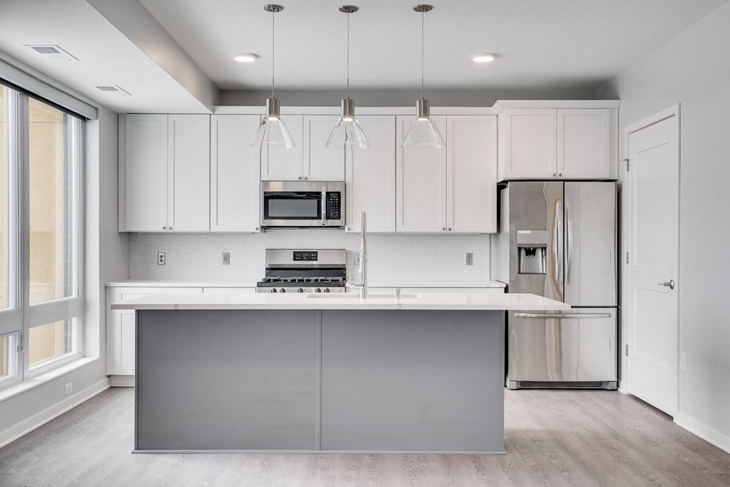Beautiful kitchen with light luxury finishes, matching stainless steel appliances, and granite countertops