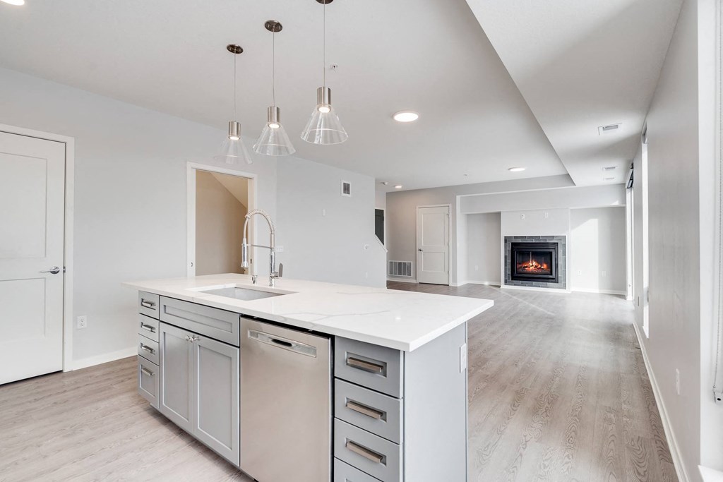 Large kitchen island with granite countertops and dishwasher in island