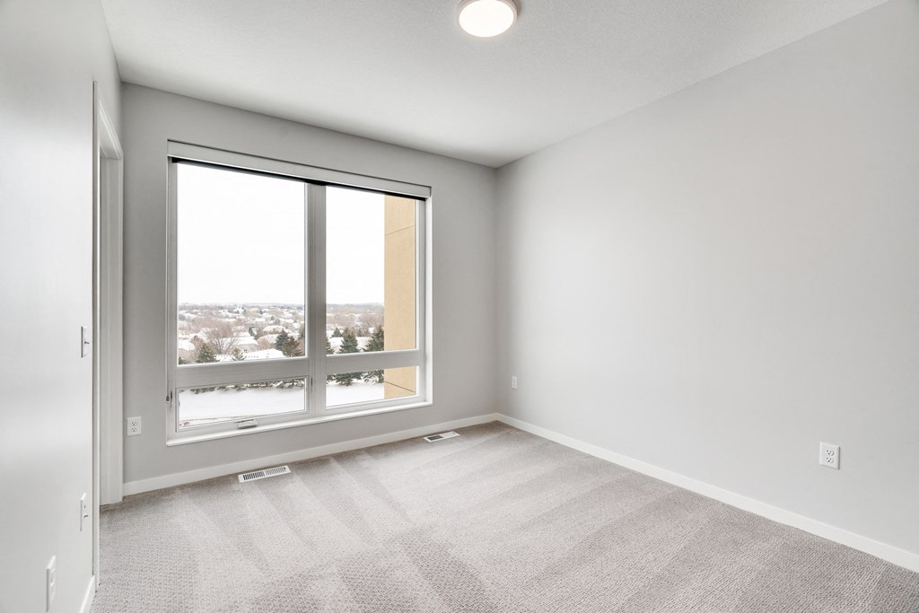Spacious bedroom with large window and natural light at Aspire at CityPlace in Woodbury, Minnesota