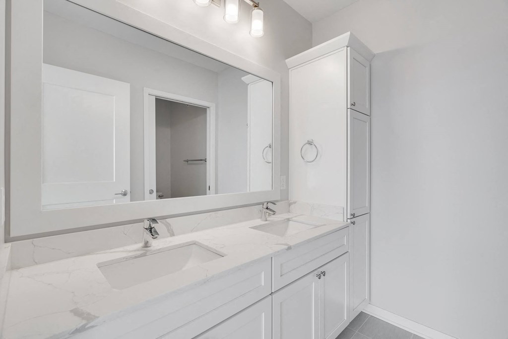 Large dual sink vanity in luxury bathroom at Aspire at CityPlace in Woodbury, Minnesota