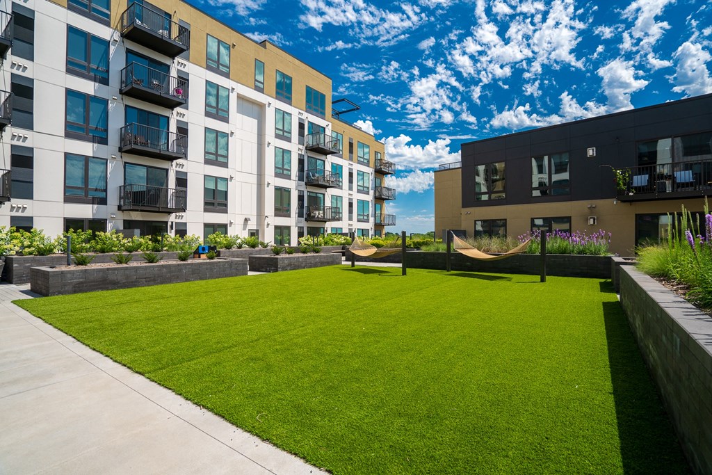 Courtyard hammock grove with a couple hammocks in grassy area at Aspire at Cityplace.