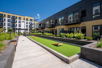 Courtyard outdoor area with cornhole playing area at Aspire at CityPlace