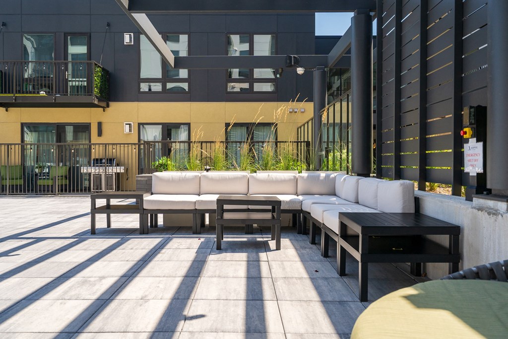 Outdoor lounge area with large sectional and 3 side tables at Aspire at CityPlace