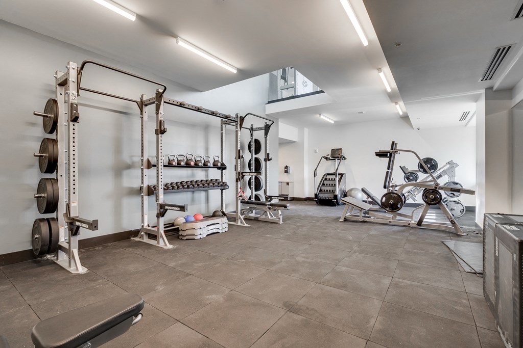 Strength training room with cushioned flooring in the fitness center at Aspire at CityPlace