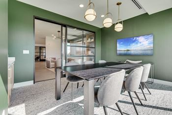 Conference room with long table and glass sliding door at luxury apartment in Woodbury