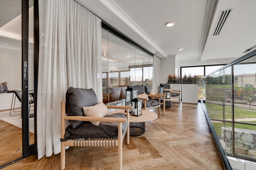 Sitting area with glass railing in upper level of the lobby at Aspire at CityPlace