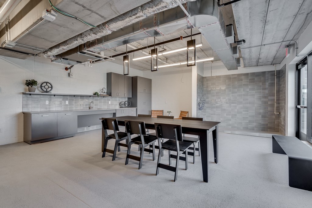 Room with concrete flooring and subway tiled walls and various seating areas at Aspire at CityPlace