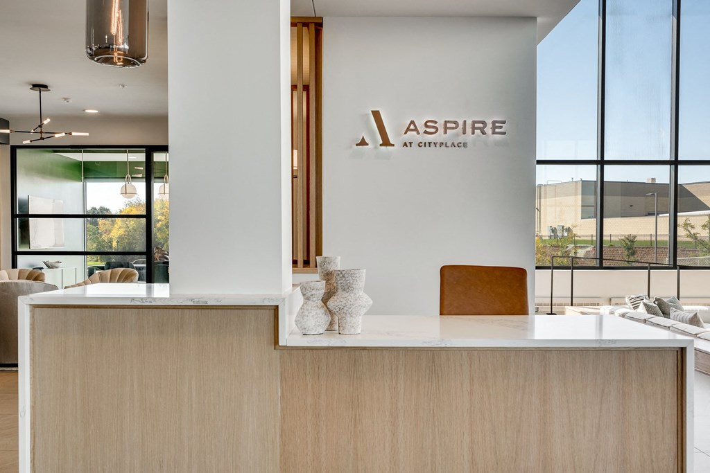Front desk with white quartz counter in the main lobby at Aspire at CityPlace in Woodbury MN