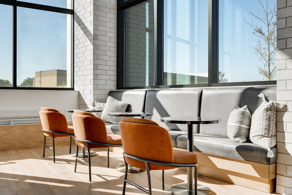 Seating area with built in booth seating and cocktail tables in the lobby at Aspire