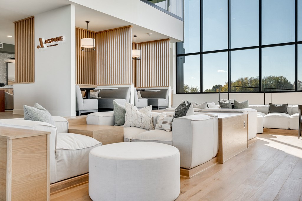 Couch seating and built in booth areas with full-wall windows in the lobby at Aspire at CityPlace