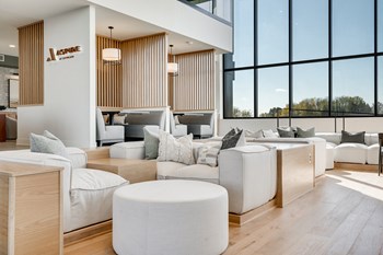 Aspire-at-CityPlace-Woodbury-MN-luxury-apartment-community-lobby Couch seating and built in booth areas with full-wall windows in the lobby at Aspire at CityPlace - Photo Gallery 4