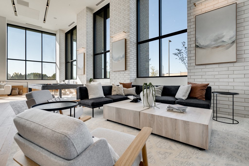 Couch seating area with large coffeee table in the center in the lobby at Aspire luxury apartments 55125