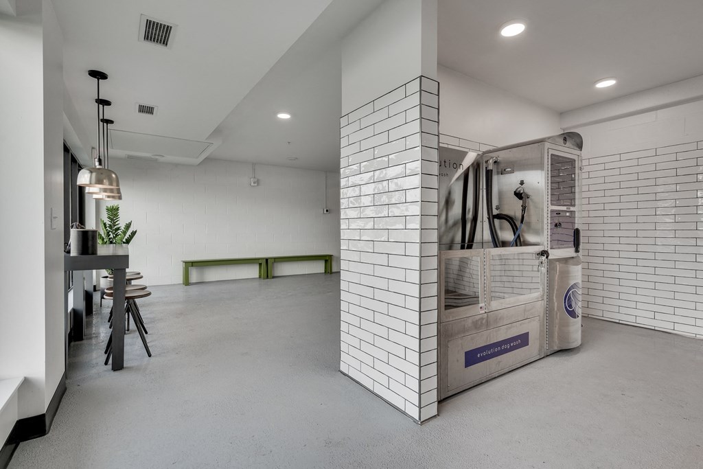 Spacious tiled room with bar seating and a built in dog wash in luxury apartment Woodbury MN