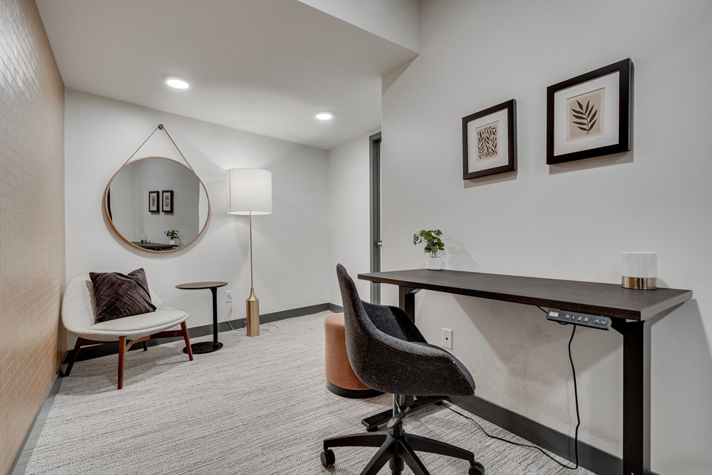 Luxury work from home suite equipped with adjustable desk and separate seating area