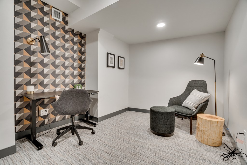 Luxury work from home suite equipped with adjustable desk and separate seating area