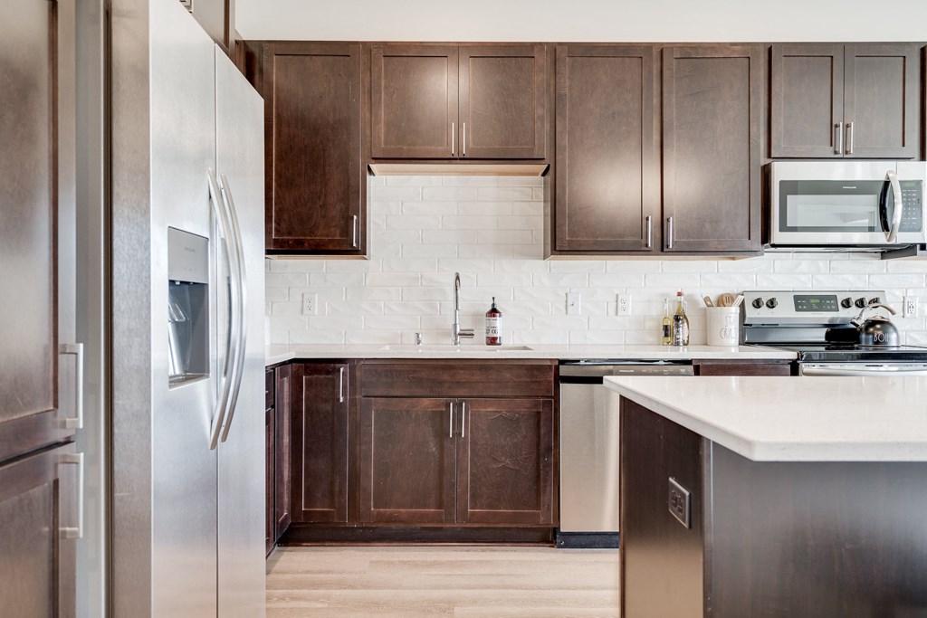 1 bedroom luxury apartment kitchen with dark brown cabinets in Woodbury MN 55125