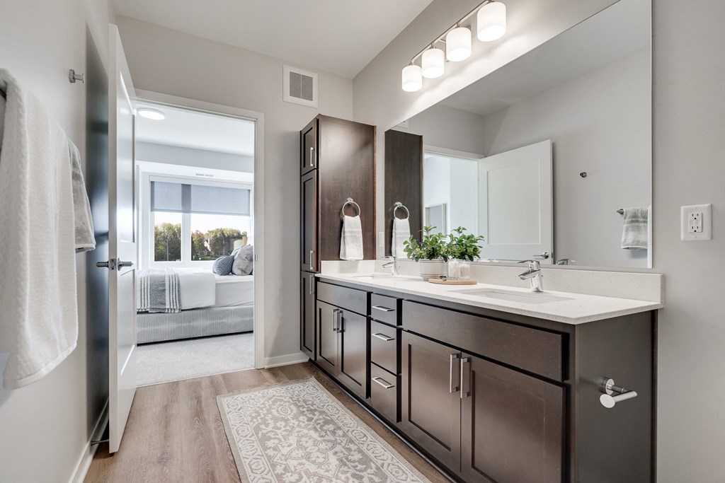 Spacious bathroom with dual vanities and lots of storage in luxury apartment in Woodbury MN 55125