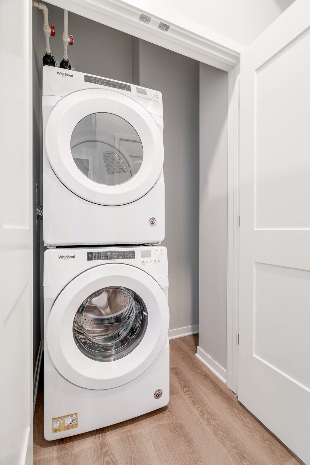 Stacked front loading washer and dryer in a closet at Aspire at CityPlace in Woodbury MN 55125