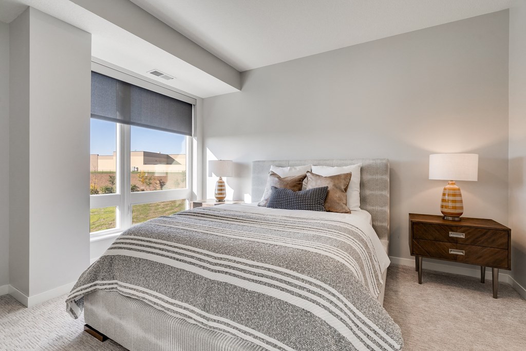 Large bedroom with floor to ceiling window in luxury apartment in Woodbury MN 55125