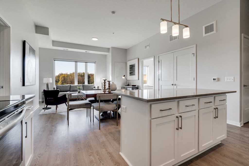 Kitchen island and living room at luxury apartment in Woodbury MN 55125
