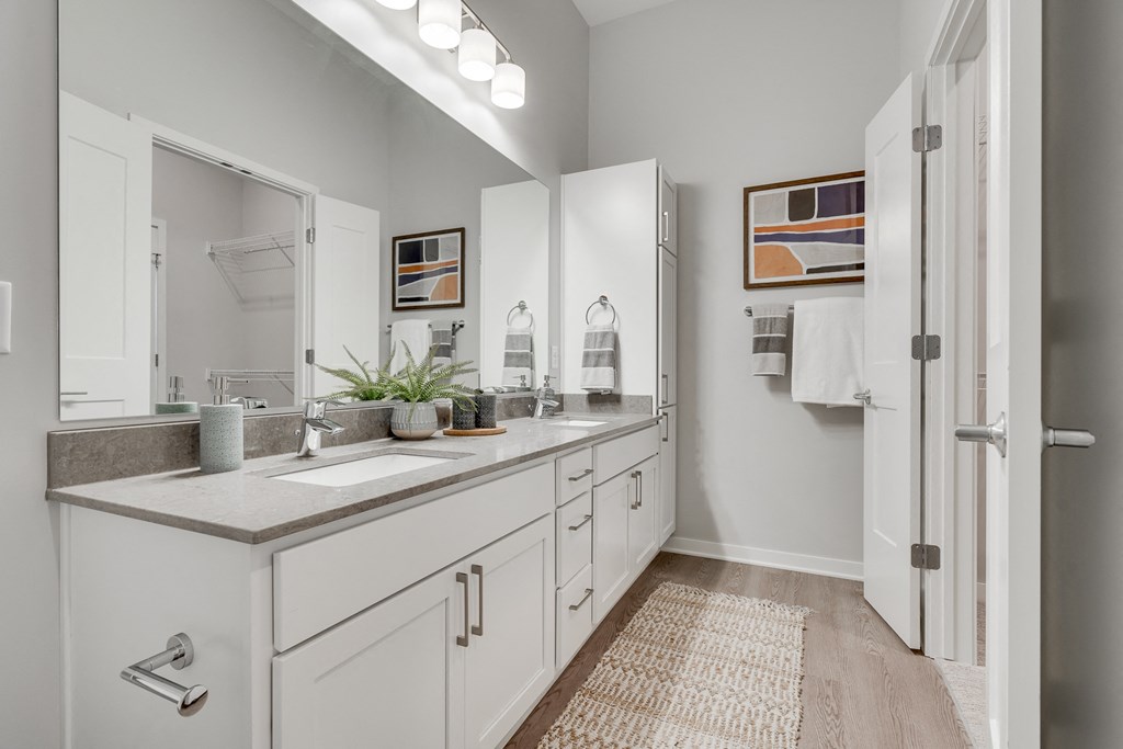 Bathroom with dual vanities and French doors in a luxury two bedroom apartment in Woodbury MN 55125