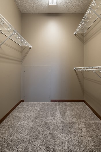 Interiors- Big walk-in closet for clothing and extra storage at the Villas of Omaha Butler Ridge in Omaha NE - Photo Gallery 34