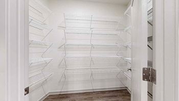 a large walk-in panty with several rows of built-in shelves